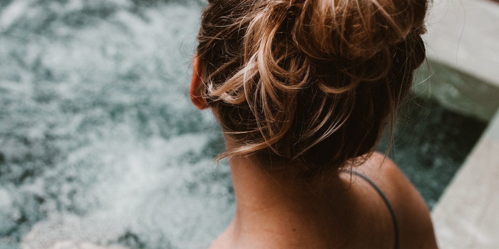 Woman bathing in a spa pool