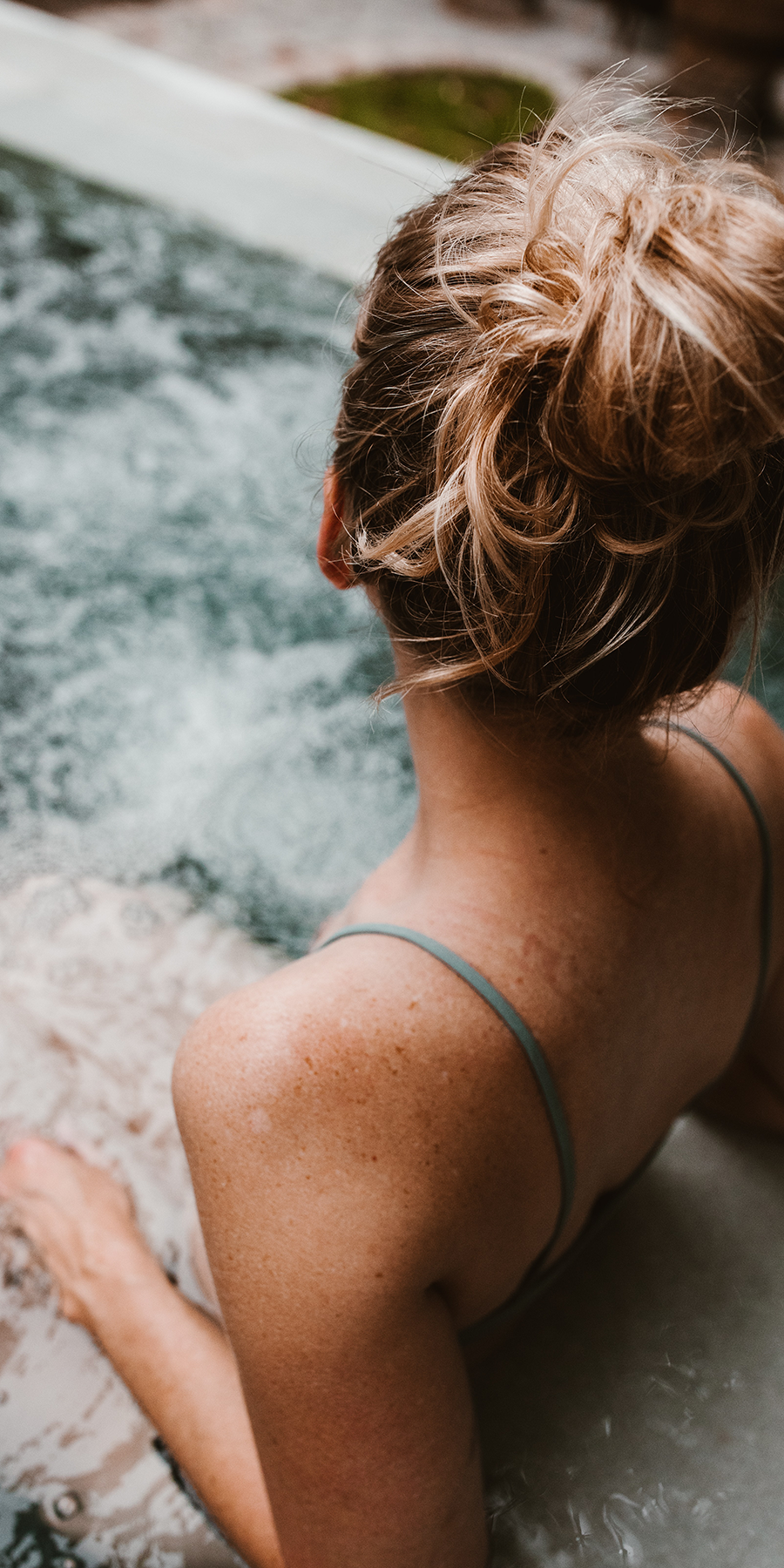 Woman bathing in a spa pool
